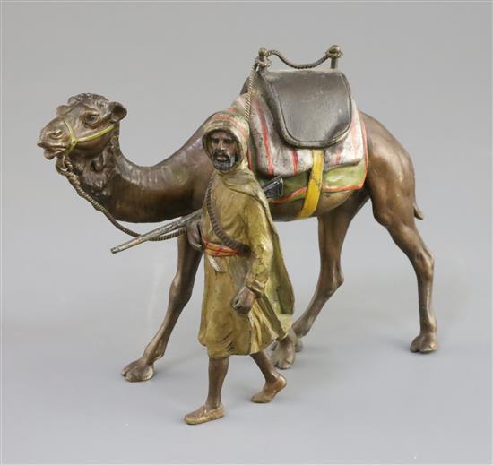 A late 19th / early 20th century Austrian cold painted bronze model of an Arab warrior walking alongside his camel, 6in.